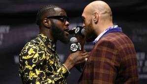 Deontay Wilder (li.) droht Tyson Fury (re.)